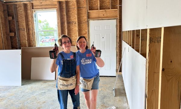 Two women participating in habitat for humanity boone county's women build