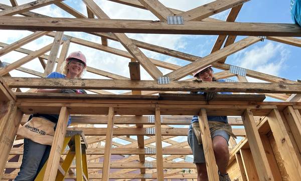 two women building a house as part of Habitat for Humanity Boone County's Women Build